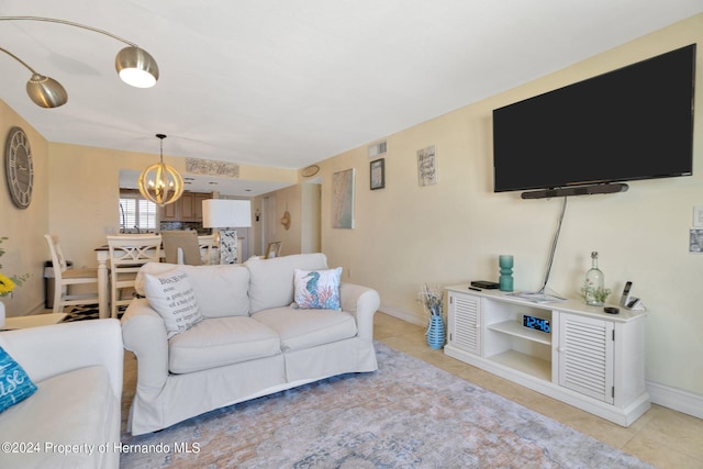 tiled living room featuring a chandelier