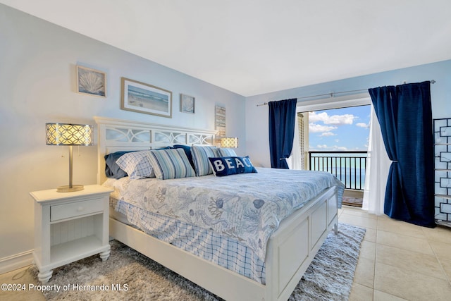 bedroom with light tile patterned floors and access to exterior