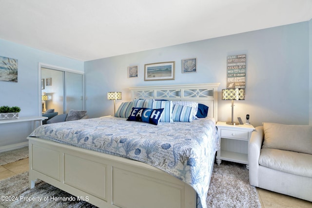 bedroom with light tile patterned floors and a closet