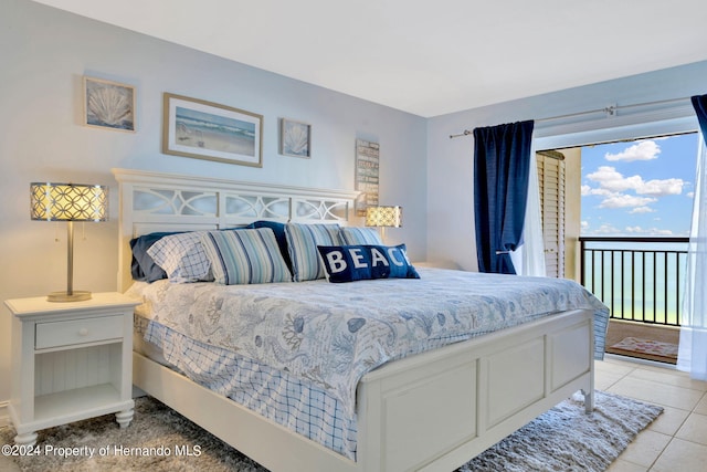 bedroom with access to exterior and light tile patterned floors