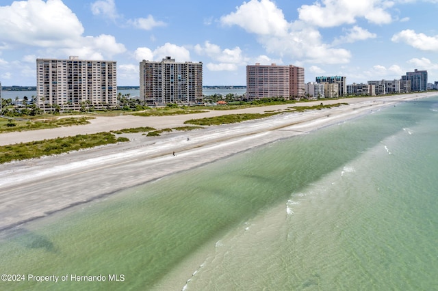 birds eye view of property featuring a beach view and a water view