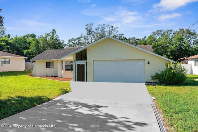 view of front of property with a garage and a front yard