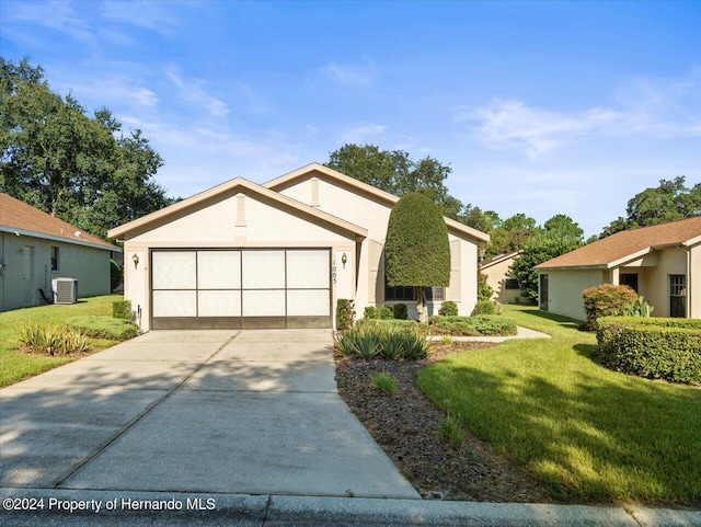 view of front facade with central air condition unit, a garage, and a front yard