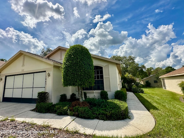 view of side of home featuring a garage and a yard