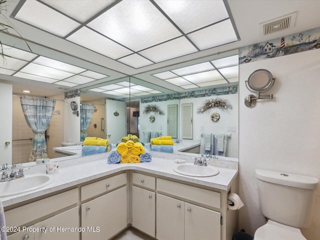 bathroom featuring toilet, vanity, and a shower with shower curtain