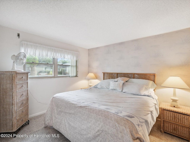 carpeted bedroom with a textured ceiling