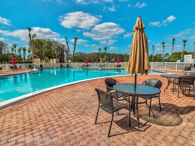 view of swimming pool with a patio area