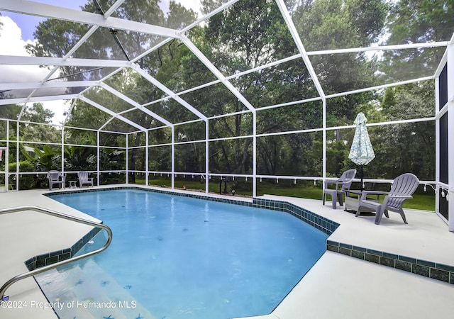 view of pool with a lanai and a patio