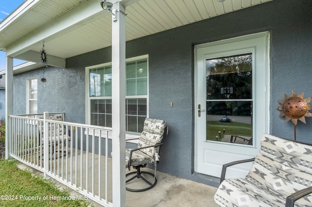 view of exterior entry with covered porch