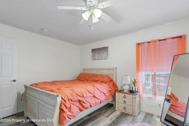 bedroom with hardwood / wood-style flooring and ceiling fan