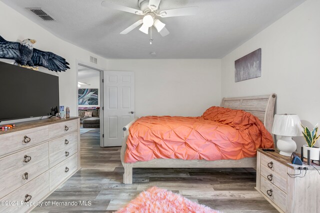 bedroom featuring dark wood-type flooring and ceiling fan