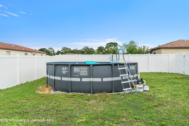 view of yard with a fenced in pool