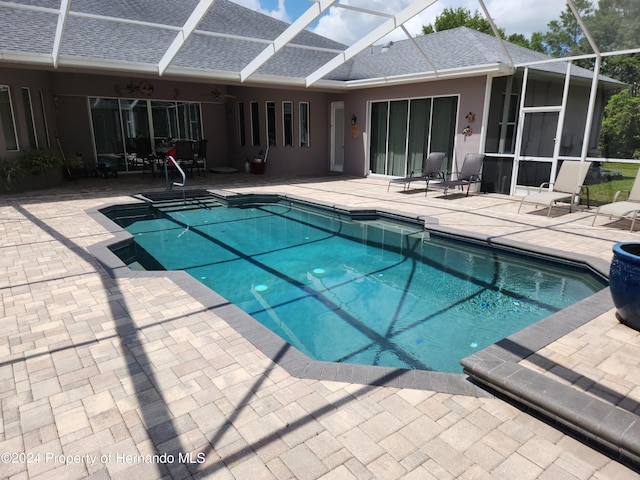 view of pool with a patio area, a lanai, and ceiling fan