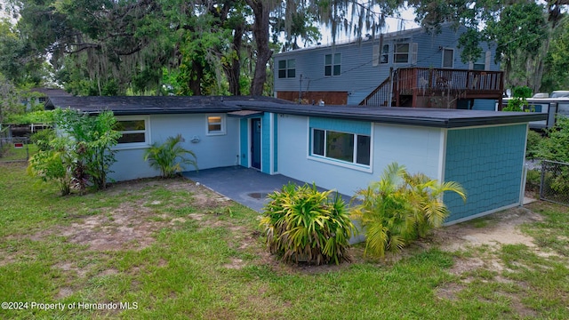 5369 Tuscawilla Dr, Weeki Wachee, FL 34607 - back of house with a wooden deck and a patio
