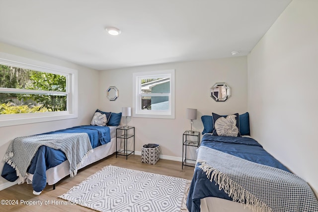 5369 Tuscawilla Dr, Weeki Wachee, FL 34607 - bedroom featuring multiple windows and wood finished floors