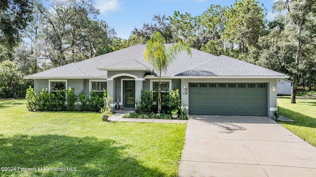 ranch-style house featuring a front lawn and a garage