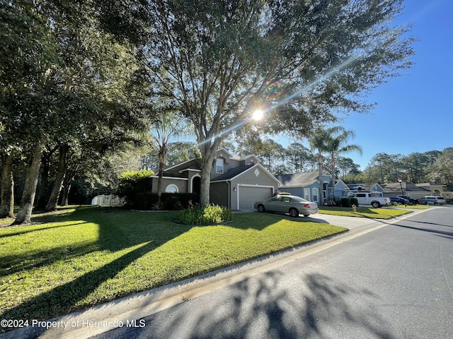 view of front of property with a garage and a front yard