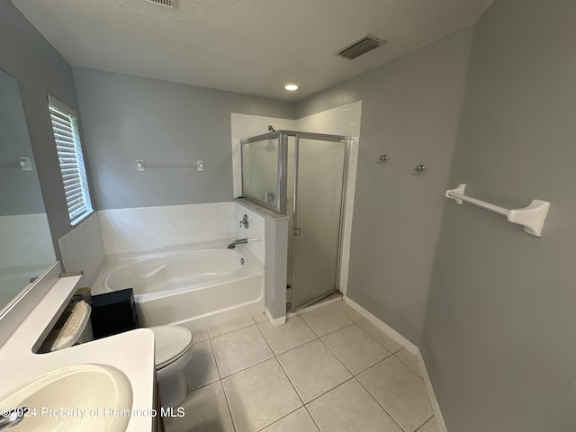 full bathroom featuring tile patterned flooring, vanity, shower with separate bathtub, and toilet