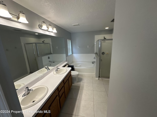 full bathroom featuring tile patterned flooring, separate shower and tub, vanity, a textured ceiling, and toilet