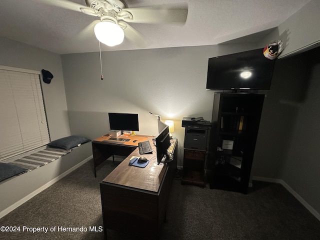 carpeted home office with a textured ceiling and ceiling fan