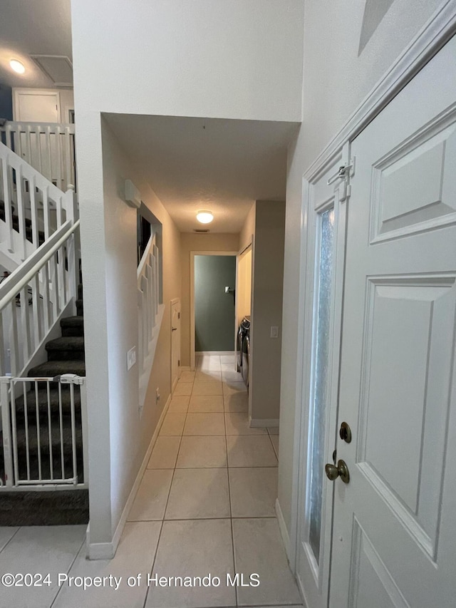 hall featuring light tile patterned flooring