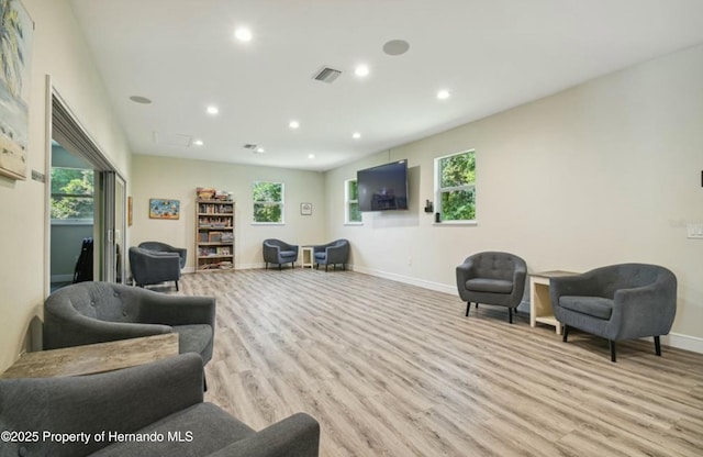 living room with a wealth of natural light and light hardwood / wood-style floors