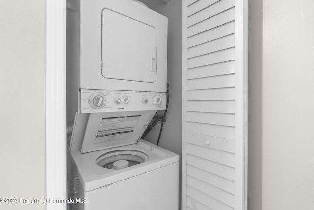 laundry area with stacked washer / dryer