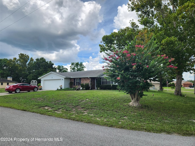 view of front of home with a garage and a front yard