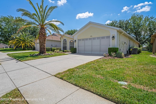 single story home featuring central air condition unit, a garage, and a front yard