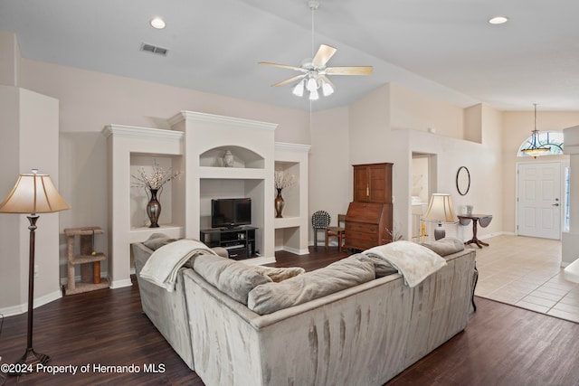 living room with high vaulted ceiling, built in features, wood-type flooring, and ceiling fan