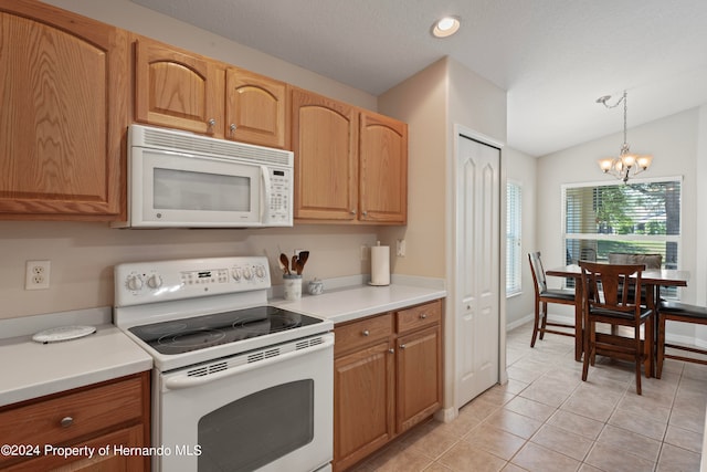 kitchen featuring light tile patterned floors, an inviting chandelier, decorative light fixtures, white appliances, and vaulted ceiling