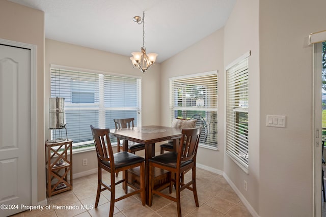 tiled dining room featuring vaulted ceiling and a notable chandelier