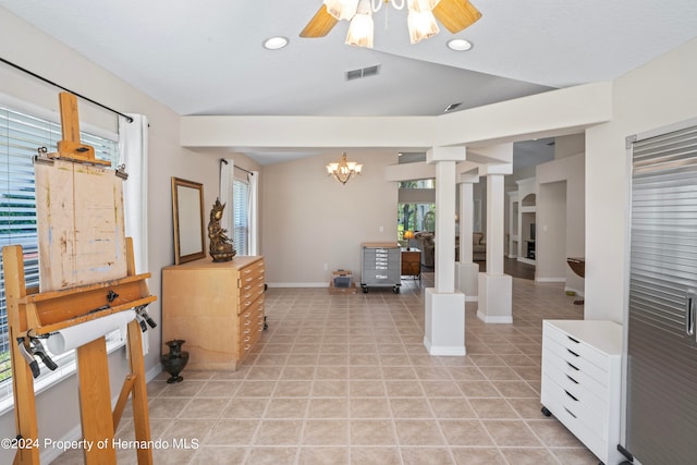 interior space with ornate columns and ceiling fan with notable chandelier