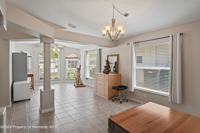 interior space with light tile patterned floors and ceiling fan with notable chandelier