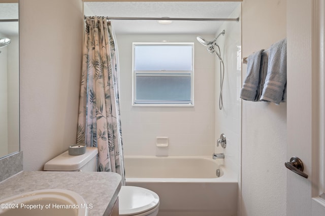 full bathroom with toilet, vanity, a textured ceiling, and shower / bathtub combination with curtain