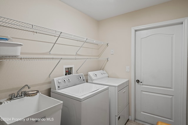 washroom featuring light tile patterned floors, sink, and independent washer and dryer