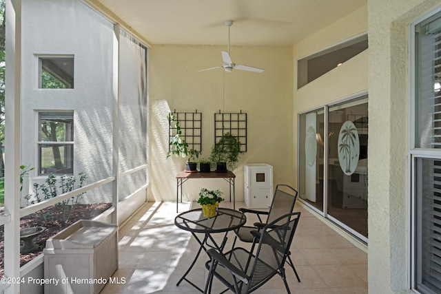 sunroom / solarium featuring lofted ceiling and ceiling fan