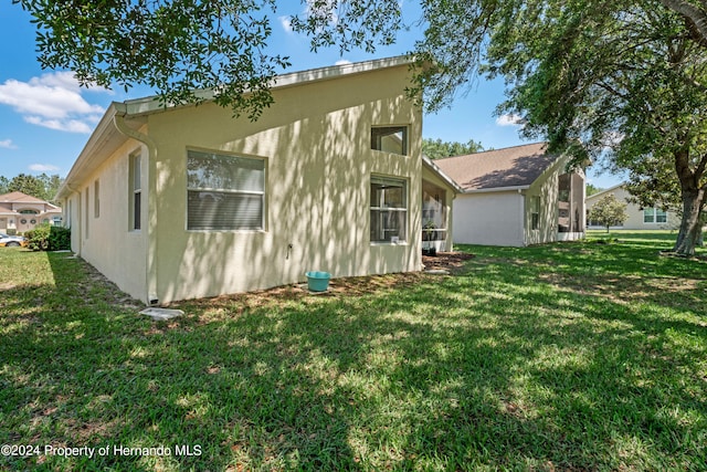 view of property exterior featuring a lawn