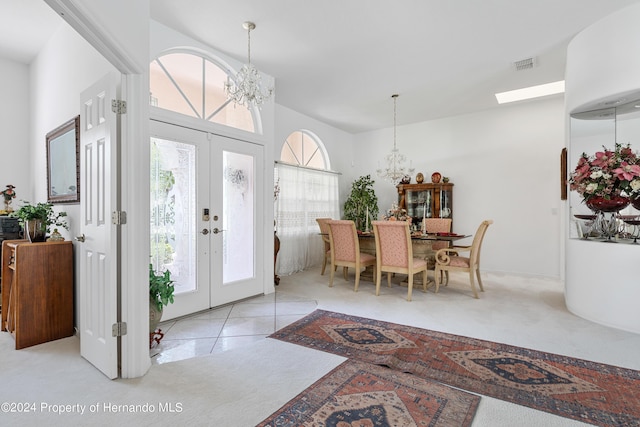21312 Preservation Dr, Land O Lakes, FL 34638 - entrance foyer featuring tile patterned floors, visible vents, french doors, and a chandelier