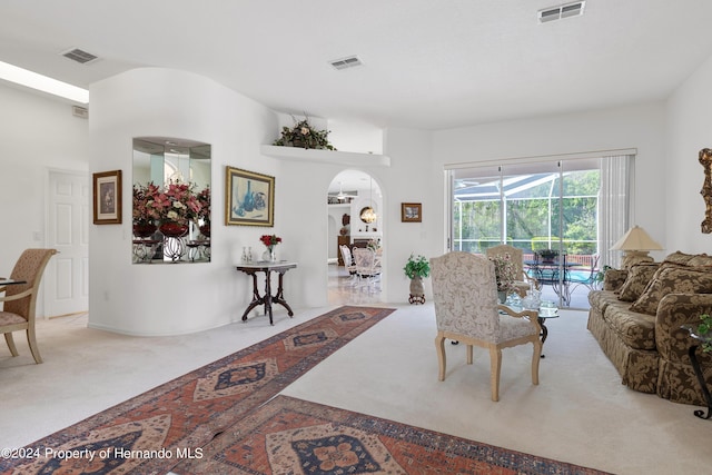 21312 Preservation Dr, Land O Lakes, FL 34638 - living area with arched walkways, carpet, and visible vents