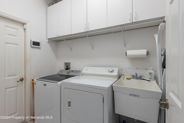 21312 Preservation Dr, Land O Lakes, FL 34638 - laundry area with cabinet space, a sink, and independent washer and dryer