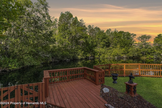 21312 Preservation Dr, Land O Lakes, FL 34638 - deck at dusk with a water view, fence, and a yard
