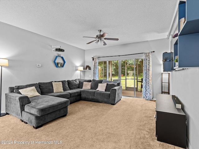 living room featuring carpet floors, a textured ceiling, and ceiling fan