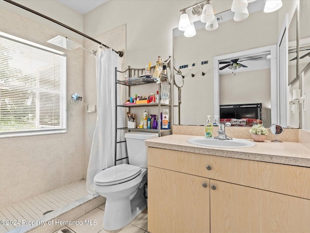 bathroom with a shower with curtain, ceiling fan, vanity, tile patterned floors, and toilet