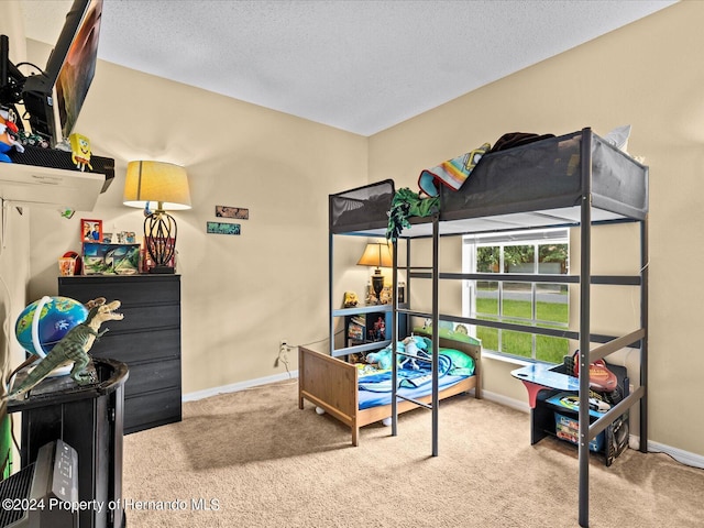 carpeted bedroom featuring a textured ceiling