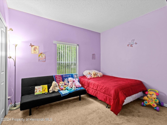 carpeted bedroom with a textured ceiling