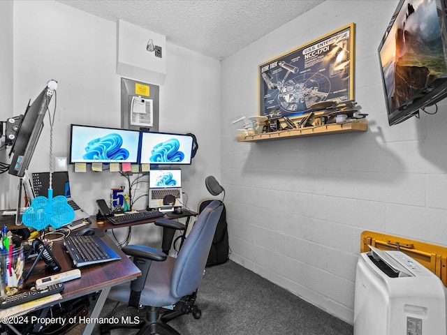 office space featuring carpet floors and a textured ceiling