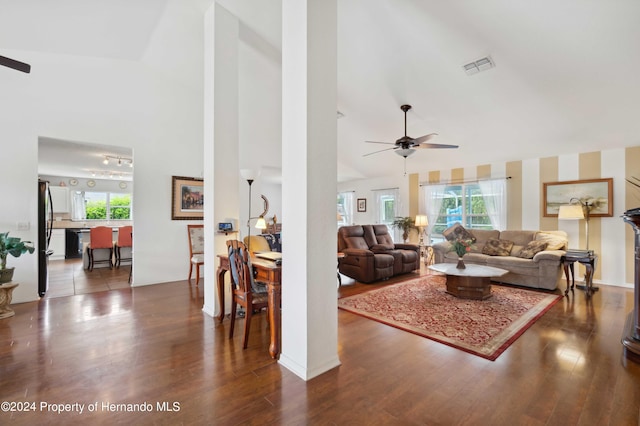 living room featuring dark wood-type flooring, ceiling fan, and high vaulted ceiling