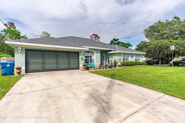 ranch-style house with a garage and a front lawn