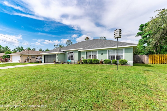 ranch-style home featuring a garage and a front lawn